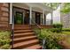 Inviting front porch with brick flooring and classic white columns, perfect for relaxing outdoors at 2174 Basque Se Dr, Smyrna, GA 30080