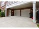 Exterior view of a two-car garage with white doors and a concrete driveway at 2174 Basque Se Dr, Smyrna, GA 30080