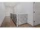 Upstairs hallway with hardwood flooring, white walls, and elegant railing at 2174 Basque Se Dr, Smyrna, GA 30080