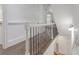 Hallway with wrought iron spindles, wood floors, and detailed trim work throughout at 2174 Basque Se Dr, Smyrna, GA 30080