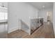 Hallway view featuring hardwood floors and white staircase railing at 2174 Basque Se Dr, Smyrna, GA 30080