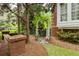 Beautifully landscaped yard with a white trellis, brick accents, and lush plantings enhancing curb appeal at 2174 Basque Se Dr, Smyrna, GA 30080