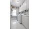 Organized laundry room equipped with modern washer and dryer, ample white cabinetry, and a functional sink at 2174 Basque Se Dr, Smyrna, GA 30080