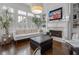 Cozy living room with fireplace, hardwood floors, and large windows offering plenty of natural light at 2174 Basque Se Dr, Smyrna, GA 30080