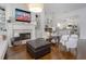 Bright living room featuring a fireplace, hardwood floors, and open access to the kitchen at 2174 Basque Se Dr, Smyrna, GA 30080