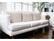 Bright living room with white sofa, decorative pillows, and hardwood flooring at 2174 Basque Se Dr, Smyrna, GA 30080