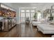 Bright sitting room with hardwood floors, mirrored console, large TV, and plenty of natural light at 2174 Basque Se Dr, Smyrna, GA 30080