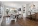 Open-concept living room with hardwood floors, fireplace, and large windows with plantation shutters at 2174 Basque Se Dr, Smyrna, GA 30080