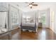 Spacious primary bedroom featuring hardwood floors, four-poster bed, and patterned wallpaper at 2174 Basque Se Dr, Smyrna, GA 30080