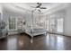 Spacious main bedroom boasting modern tray ceilings, decorative walls, and a luxurious four-poster bed at 2174 Basque Se Dr, Smyrna, GA 30080
