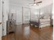 Primary bedroom featuring a four poster bed, hardwood floors and patterned wallpaper at 2174 Basque Se Dr, Smyrna, GA 30080
