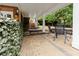Covered patio with stone flooring, providing a charming outdoor seating area with garden views at 2174 Basque Se Dr, Smyrna, GA 30080