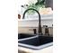 Modern black kitchen sink featuring bronze fixtures and granite countertops at 2174 Basque Se Dr, Smyrna, GA 30080