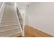 Bright foyer with carpeted stairs, hardwood floors, and decorative iron railing at 2174 Basque Se Dr, Smyrna, GA 30080
