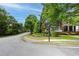 Charming two-story brick home with a welcoming front porch and beautifully landscaped front yard on corner lot at 2174 Basque Se Dr, Smyrna, GA 30080