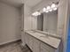 Dual-sink bathroom with granite counters and ample lighting at 28 Loth Wages (Lot 28) Rd, Dacula, GA 30019