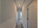 Hallway with hardwood floors and white doors, offering a clean and modern look at 28 Loth Wages (Lot 28) Rd, Dacula, GA 30019