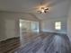 Bright living room boasting vaulted ceiling, ceiling fan, luxury vinyl plank flooring, and open floor plan at 28 Loth Wages (Lot 28) Rd, Dacula, GA 30019