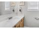 Bright bathroom with a white countertop, wooden vanity, and mirror at 4914 Brown Leaf Dr, Powder Springs, GA 30127