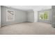 Spacious bedroom featuring neutral carpet, two windows allowing plenty of natural light, and light gray walls at 4914 Brown Leaf Dr, Powder Springs, GA 30127