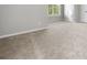 Bright bedroom featuring neutral carpet, a window allowing plenty of natural light, and light gray walls at 4914 Brown Leaf Dr, Powder Springs, GA 30127
