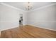 Dining area with hardwood floors, chandelier, and view to the kitchen at 4914 Brown Leaf Dr, Powder Springs, GA 30127