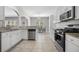 Modern kitchen features stainless steel appliances and tile flooring at 4914 Brown Leaf Dr, Powder Springs, GA 30127