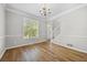 Bright living room features hardwood floors, large window, and white trim at 4914 Brown Leaf Dr, Powder Springs, GA 30127