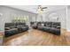 Open living room with hardwood floors, archways, and comfortable seating at 4914 Brown Leaf Dr, Powder Springs, GA 30127