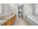 Large main bathroom featuring a soaking tub and a double vanity with granite countertops at 4914 Brown Leaf Dr, Powder Springs, GA 30127