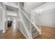 Wide staircase featuring hardwood floors and a view to the living room at 4914 Brown Leaf Dr, Powder Springs, GA 30127
