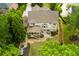 Aerial view of a beautifully landscaped backyard with a patio, water feature, and lush greenery at 5045 Huntwood Way, Roswell, GA 30075