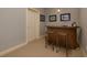 Basement bar with wooden counter and two bar stools near a door at 5045 Huntwood Way, Roswell, GA 30075