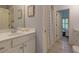Bright bathroom featuring a white vanity with a solid surface countertop and decor at 5045 Huntwood Way, Roswell, GA 30075