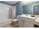 Well-lit bathroom with a shower-tub combo, vanity with storage, and neutral finishes at 5045 Huntwood Way, Roswell, GA 30075