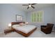 Comfortable bedroom featuring a wooden bed frame, chair, and bright window at 5045 Huntwood Way, Roswell, GA 30075