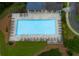 Aerial view of a large community pool surrounded by lounge chairs and greenery in a serene setting at 5045 Huntwood Way, Roswell, GA 30075