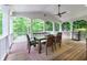 Enjoy the backyard view from this covered porch with seating and an outdoor grill at 5045 Huntwood Way, Roswell, GA 30075