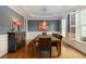 Bright dining room features a dark accent wall, wainscoting, and a chandelier at 5045 Huntwood Way, Roswell, GA 30075