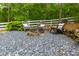 Fire pit area with chairs, surrounded by decorative rocks and wooded scenery at 5045 Huntwood Way, Roswell, GA 30075