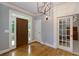 Welcoming foyer boasts gleaming hardwood floors and a modern chandelier at 5045 Huntwood Way, Roswell, GA 30075