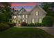 Charming two-story brick home with well-manicured landscaping, a covered porch, and inviting curb appeal at 5045 Huntwood Way, Roswell, GA 30075