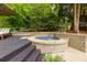 Outdoor hot tub with wooden deck, brick surround, and backyard views at 5045 Huntwood Way, Roswell, GA 30075