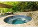 Relaxing hot tub with waterfall feature, surrounded by lush greenery at 5045 Huntwood Way, Roswell, GA 30075