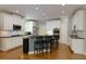 Modern kitchen with white cabinets, black countertops, and stainless steel appliances at 5045 Huntwood Way, Roswell, GA 30075
