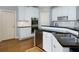 Well-equipped kitchen with stainless steel appliances, dark countertops, and white cabinets at 5045 Huntwood Way, Roswell, GA 30075