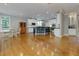 Open-concept kitchen featuring white cabinets, stainless steel appliances, and wooden floor at 5045 Huntwood Way, Roswell, GA 30075
