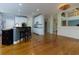Spacious kitchen featuring white cabinets, a wine rack, an island with seating, and wood floors at 5045 Huntwood Way, Roswell, GA 30075