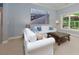 Comfortable living room with a window view and a bridge print above the couch at 5045 Huntwood Way, Roswell, GA 30075