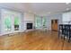 Inviting living room with a fireplace and an adjacent dining area next to the kitchen at 5045 Huntwood Way, Roswell, GA 30075